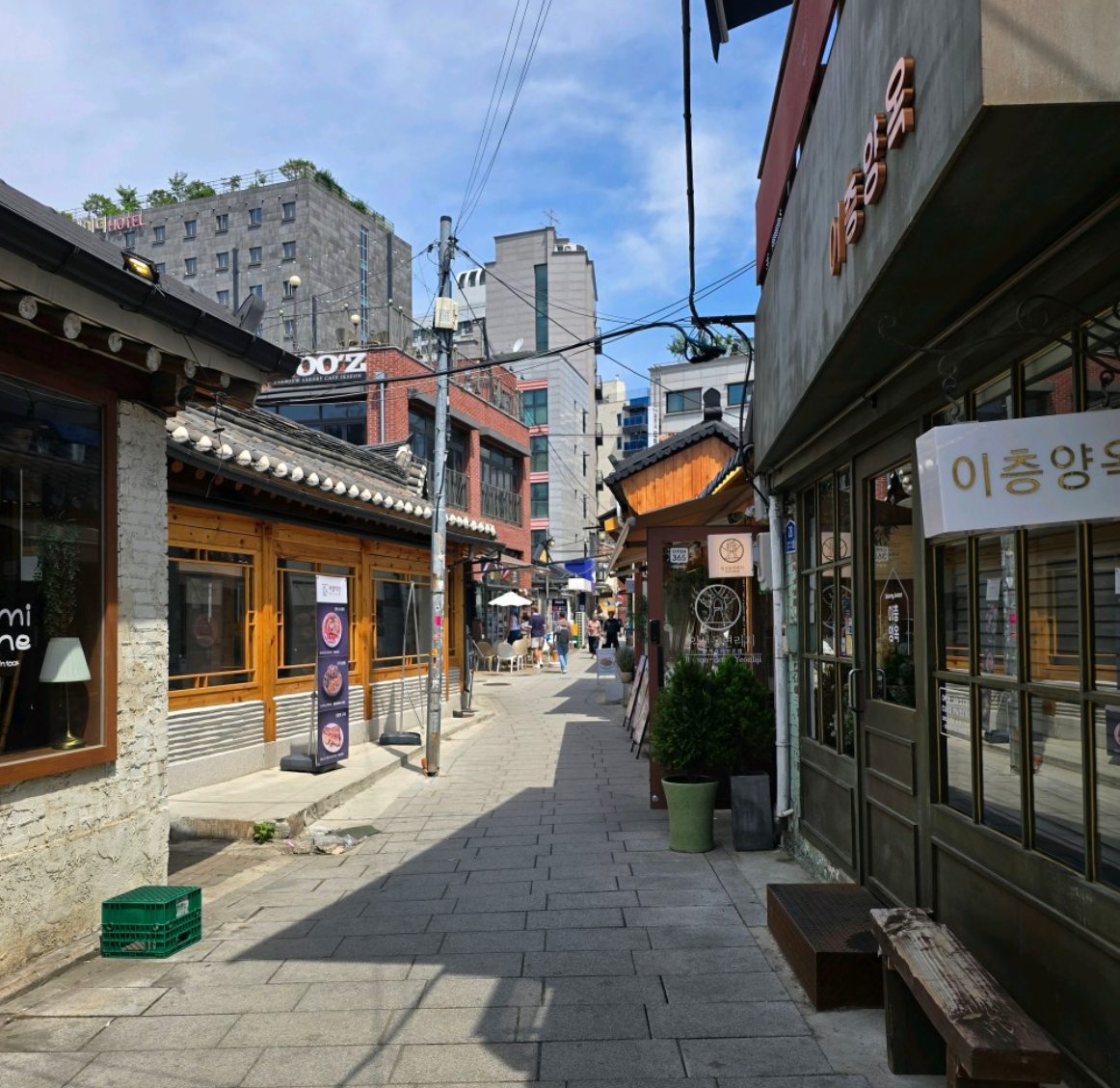 A narrow sunlit lane lined with renovated hanok shops in Ikseon-dong, Seoul