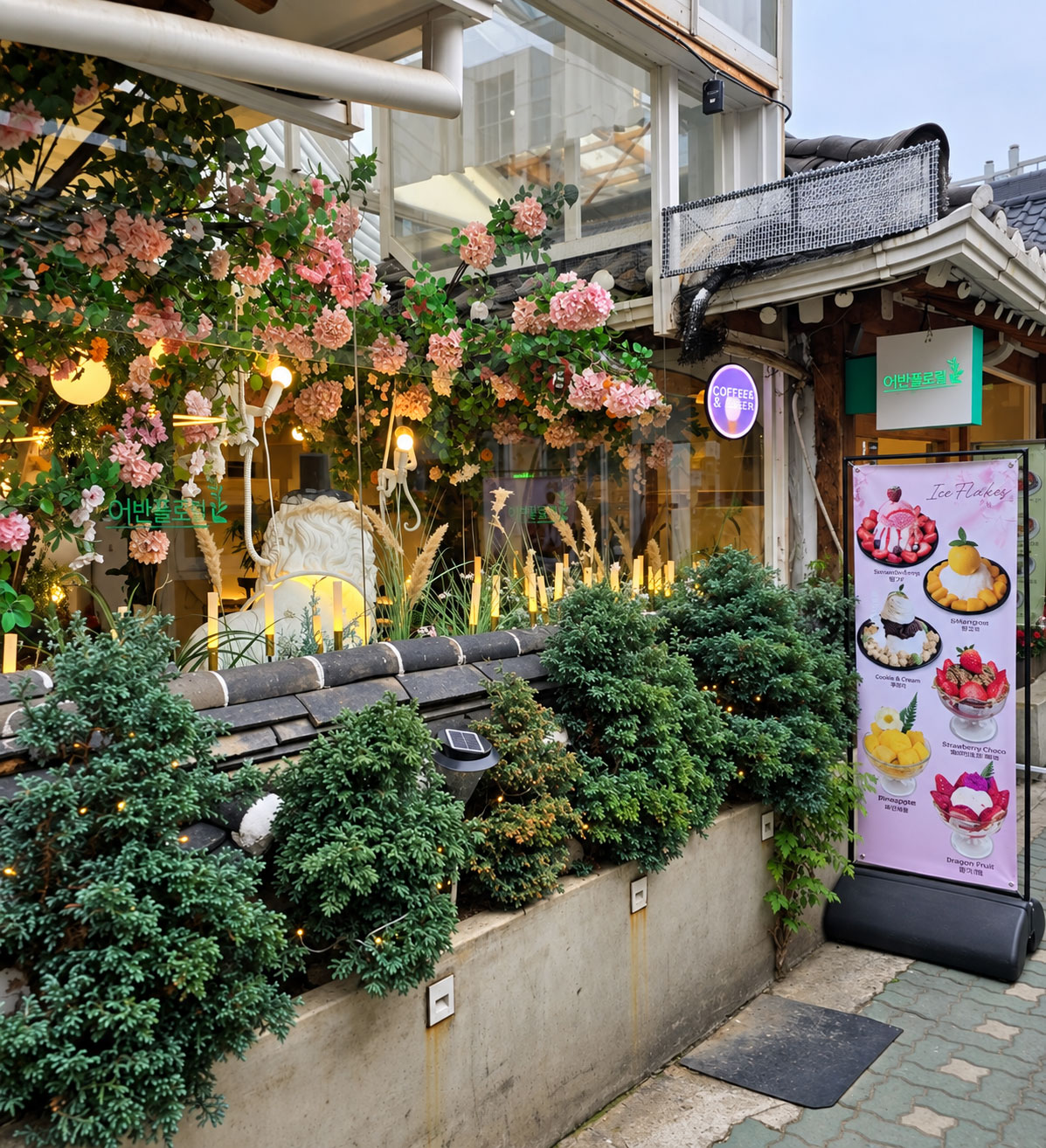 A flower-filled café storefront beneath a hanok roof in Ikseon-dong